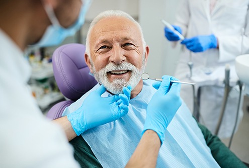 a man smiling in a dental chair