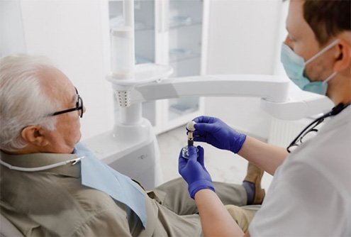 Dentist and senior patient discussing dental implants