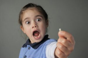 Kid shocked at her knocked out tooth
