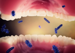 a 3D illustration of an open mouth filled with bacteria